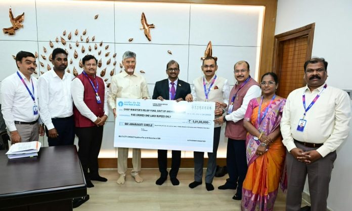 SBI delegation presenting a ₹5.01 crore relief cheque to Andhra Pradesh Chief Minister Chandrababu Naidu.